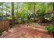 Backyard view featuring wood deck, tall trees, mature landscaping, and fence line at 2852 Rue Sans Famille, Raleigh, NC 27607