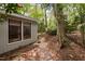 Beautiful backyard with mature trees and stone path leading away from the home at 2852 Rue Sans Famille, Raleigh, NC 27607