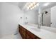 Well-lit bathroom with double sinks, tile flooring, and a large mirror at 2852 Rue Sans Famille, Raleigh, NC 27607