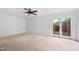 Spacious bedroom featuring a ceiling fan, neutral carpeting, and sliding glass doors to the outside deck at 2852 Rue Sans Famille, Raleigh, NC 27607