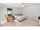 Cozy bedroom featuring a ceiling fan, natural lighting, and comfortable furnishings at 2852 Rue Sans Famille, Raleigh, NC 27607