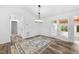 Bright dining room with wood floors, stylish light fixture, and a view of the outdoors through glass doors at 2852 Rue Sans Famille, Raleigh, NC 27607