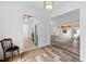 Inviting entryway showcasing kitchen and sunroom access, enhanced by a decorative chair and stylish wood flooring at 2852 Rue Sans Famille, Raleigh, NC 27607