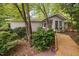 Charming exterior view of a well-maintained home featuring a wooden walkway and lush landscaping around the house at 2852 Rue Sans Famille, Raleigh, NC 27607