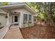 The home's entrance boasts a wooden ramp, leading to a covered porch with white railings and a glass-paneled front door at 2852 Rue Sans Famille, Raleigh, NC 27607
