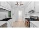 Well-lit kitchen with white cabinets, modern appliances, and a sleek black sink basin at 2852 Rue Sans Famille, Raleigh, NC 27607