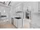 Open-concept kitchen area with stainless steel appliances, a black sink, and views into the adjacent rooms at 2852 Rue Sans Famille, Raleigh, NC 27607