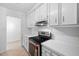 Close-up of the kitchen featuring stainless steel appliances, white countertops, and ample cabinet space at 2852 Rue Sans Famille, Raleigh, NC 27607