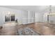 Open-concept living area with wood-look floors, white shelving, and large windows offering views of the outdoor scenery at 2852 Rue Sans Famille, Raleigh, NC 27607