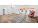 Spacious living room showcasing wood-look floors, a patterned rug, and double glass doors leading to another room at 2852 Rue Sans Famille, Raleigh, NC 27607