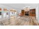 Spacious living room featuring a stone fireplace, built-in bookcases, wood floors, and natural light from a skylight at 2852 Rue Sans Famille, Raleigh, NC 27607