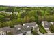Aerial view of neighborhood homes next to a wooded lake at 292 Joshua Glen Ln, Cary, NC 27519