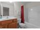 Bathroom with tub/shower, vanity with sink, toilet and red shower curtain at 292 Joshua Glen Ln, Cary, NC 27519