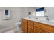 Bathroom featuring a double sink vanity, wooden cabinets, and neutral colored tile at 292 Joshua Glen Ln, Cary, NC 27519