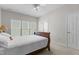 Bedroom featuring a bed with wood frame, white linens and a window with bright, natural light at 292 Joshua Glen Ln, Cary, NC 27519
