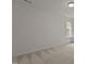 Empty carpeted bedroom with white walls, a window, and neutral decor at 292 Joshua Glen Ln, Cary, NC 27519