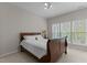 Bedroom featuring a bed with wood frame, white linens and a window with bright, natural light at 292 Joshua Glen Ln, Cary, NC 27519