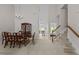 Open-concept dining area with a classic chandelier and seamless access to other living areas at 292 Joshua Glen Ln, Cary, NC 27519