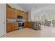 Bright kitchen boasting ample wood cabinetry, modern appliances, and an adjacent sunroom area at 292 Joshua Glen Ln, Cary, NC 27519