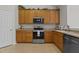 Kitchen featuring wooden cabinets, a stainless steel range, and countertops at 292 Joshua Glen Ln, Cary, NC 27519