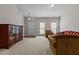 Bright living room area with neutral walls, carpet flooring, and great natural light from large windows at 292 Joshua Glen Ln, Cary, NC 27519