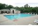 Community pool with lounge chairs and tables for relaxing on a sunny day at 292 Joshua Glen Ln, Cary, NC 27519