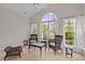 Sunroom with wicker seating, a vaulted ceiling, and large windows with a view of the lake at 292 Joshua Glen Ln, Cary, NC 27519