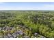 An aerial shot of a neighborhood filled with lush trees in a quiet area at 301 Marsh Landing Dr, Holly Springs, NC 27540