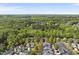 An aerial view displays a dense neighborhood nestled amongst lush greenery at 301 Marsh Landing Dr, Holly Springs, NC 27540