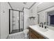 A bathroom features a glass enclosed shower, modern lighting, and stylish tile flooring, enhancing the spa-like feel at 301 Marsh Landing Dr, Holly Springs, NC 27540