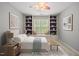 Comfortable bedroom with built-in bookshelves, a window seat, and stylish decor at 301 Marsh Landing Dr, Holly Springs, NC 27540