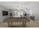 Spacious game room featuring a pool table, comfortable seating, and ample natural light at 301 Marsh Landing Dr, Holly Springs, NC 27540