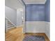 Entryway with wood floors, stairs, and detailed molding, leading to additional rooms in the home at 301 Marsh Landing Dr, Holly Springs, NC 27540