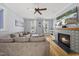 Inviting living room with a cozy fireplace, neutral color palette, plush seating, and lots of natural light at 301 Marsh Landing Dr, Holly Springs, NC 27540