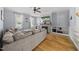 Spacious living room with fireplace, built-in shelving, a ceiling fan, and neutral furnishings at 301 Marsh Landing Dr, Holly Springs, NC 27540
