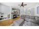 Spacious living room with fireplace, built-in shelving, a ceiling fan, and neutral furnishings at 301 Marsh Landing Dr, Holly Springs, NC 27540