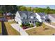 Aerial view of a two-story home with a well-manicured lawn, an attached garage, and a spacious driveway at 3037 Freeman Farm Way, Rolesville, NC 27571