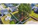 Aerial view of fenced backyard with mature trees, patio, pool, and manicured lawn at 3037 Freeman Farm Way, Rolesville, NC 27571