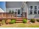 Charming back deck with wood railing, steps to yard, and space for outdoor seating, perfect for entertaining at 3037 Freeman Farm Way, Rolesville, NC 27571