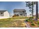 Expansive backyard featuring a well-manicured lawn, a wooden deck, and beautiful landscaping along the property line at 3037 Freeman Farm Way, Rolesville, NC 27571