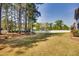 Large backyard with mature trees, a white fence, and plenty of space for outdoor activities and relaxation at 3037 Freeman Farm Way, Rolesville, NC 27571