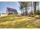 Large backyard with lush lawn, mature trees providing shade, and a well-maintained fence for privacy at 3037 Freeman Farm Way, Rolesville, NC 27571