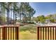 Expansive backyard view from the wooden deck, featuring mature trees and manicured lawn at 3037 Freeman Farm Way, Rolesville, NC 27571