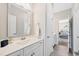 Bright bathroom featuring a white vanity, chrome fixtures, and a view into the bedroom at 3037 Freeman Farm Way, Rolesville, NC 27571
