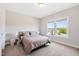 Bright bedroom with a comfortable bed, soft carpeting, and large windows overlooking a neighborhood street at 3037 Freeman Farm Way, Rolesville, NC 27571