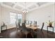Elegant dining room boasting a coffered ceiling, chandelier, and dark wood floors at 3037 Freeman Farm Way, Rolesville, NC 27571