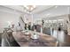 Elegant dining area offering dark wood floors, recessed lighting, and a modern table at 3037 Freeman Farm Way, Rolesville, NC 27571