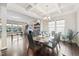 Dining area with a table set for six, chandelier lighting, coffered ceilings, and a view to the living room at 3037 Freeman Farm Way, Rolesville, NC 27571