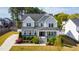 Charming two-story home with a covered front porch, beautiful landscaping, and a well-maintained lawn at 3037 Freeman Farm Way, Rolesville, NC 27571