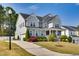 Well-maintained two-story home with a spacious driveway, an attached garage, and professionally landscaped grounds at 3037 Freeman Farm Way, Rolesville, NC 27571